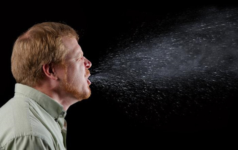 Man Sneezing Germs Shown Spreading (sneeze in progress)
