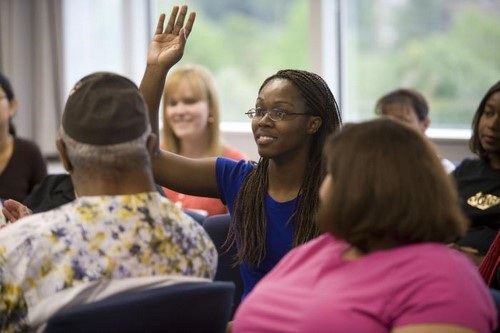 African American Woman Asking Question at Town Hall Meeting