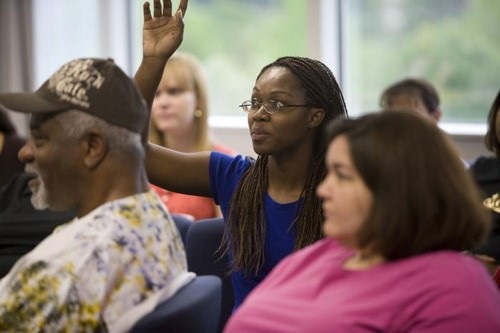 African American Woman Asking Question at Town Hall Meeting