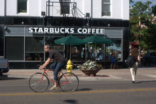 Man on Bicycle in front of Starbucks