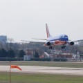 Dallas Texas in Background as Southwest Airlines Jet Lands at Love Field