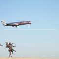 Statue at DFW Airport with Plane Flying Overhead